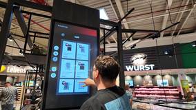 customer-using-interactive-touchscreen-kiosk.jpg